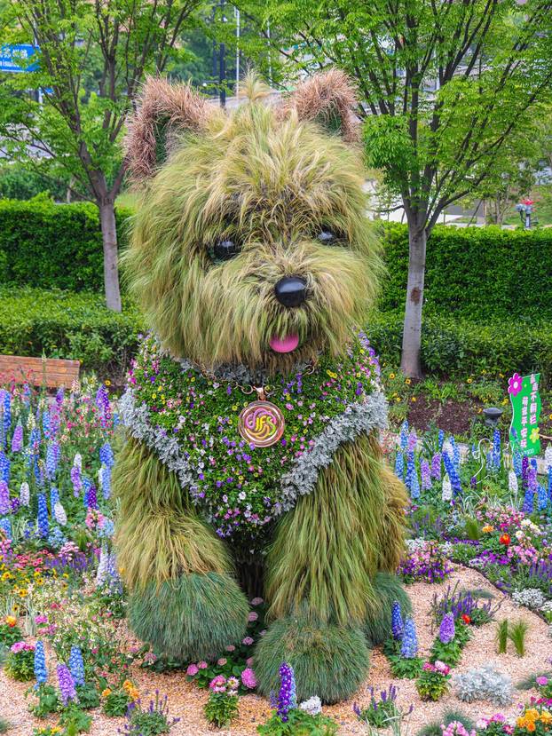 SHANGHAI, CHINA - APRIL 19: A 5.2-meter-tall puppy made of flowers and greenery steals the spotlight at the ongoing 2026