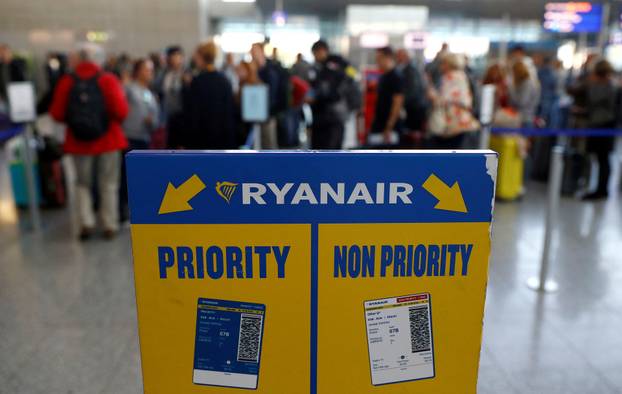 FILE PHOTO: Stranded passengers of low-cost air carrier Ryanair queue for hotel vouchers or new tickets during European wide protests and strikes for Ryanair employees in demand for better working conditions  at Fraport airport in Frankfurt
