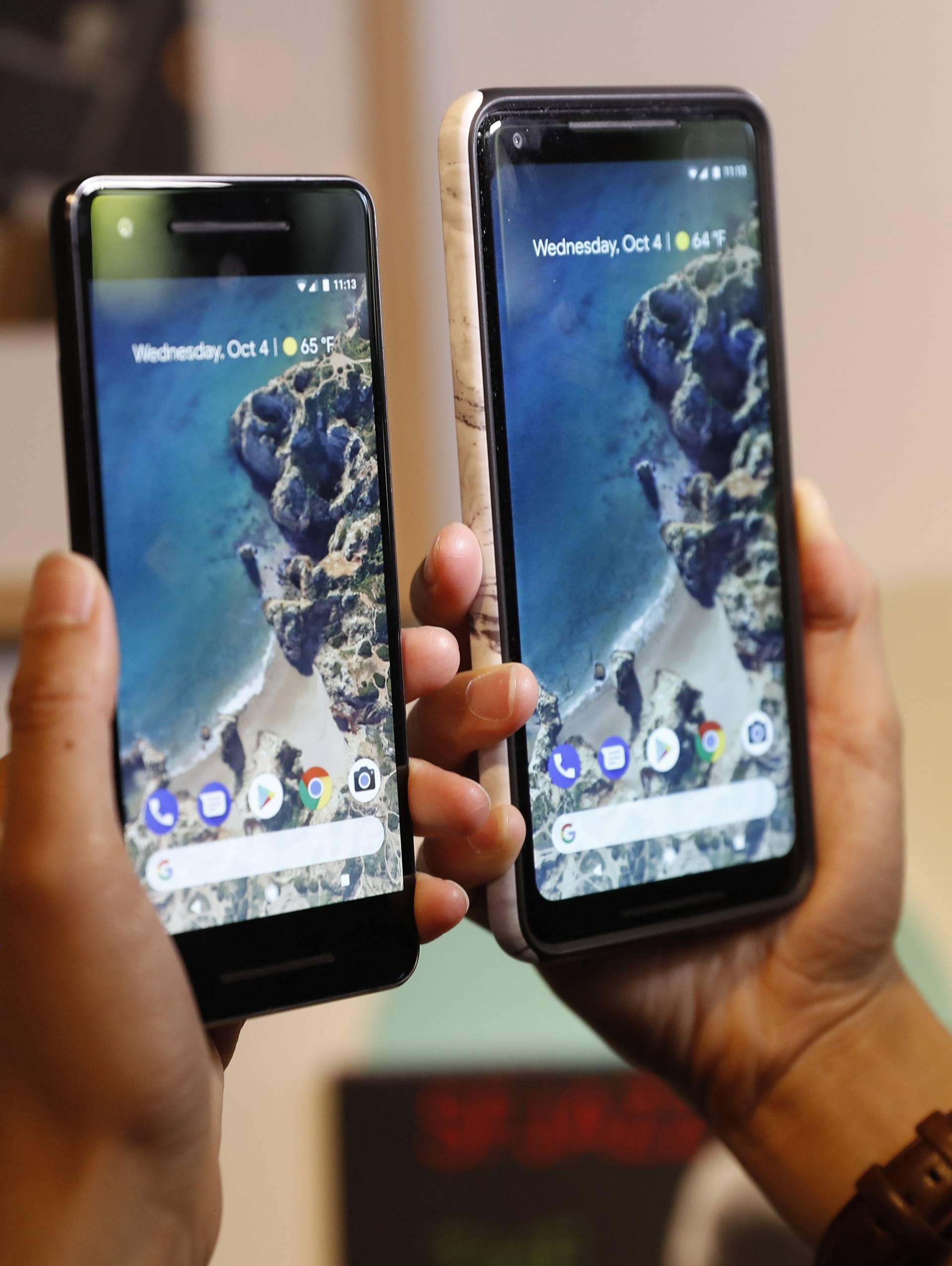 People compare Google phones during a launch event in San Francisco