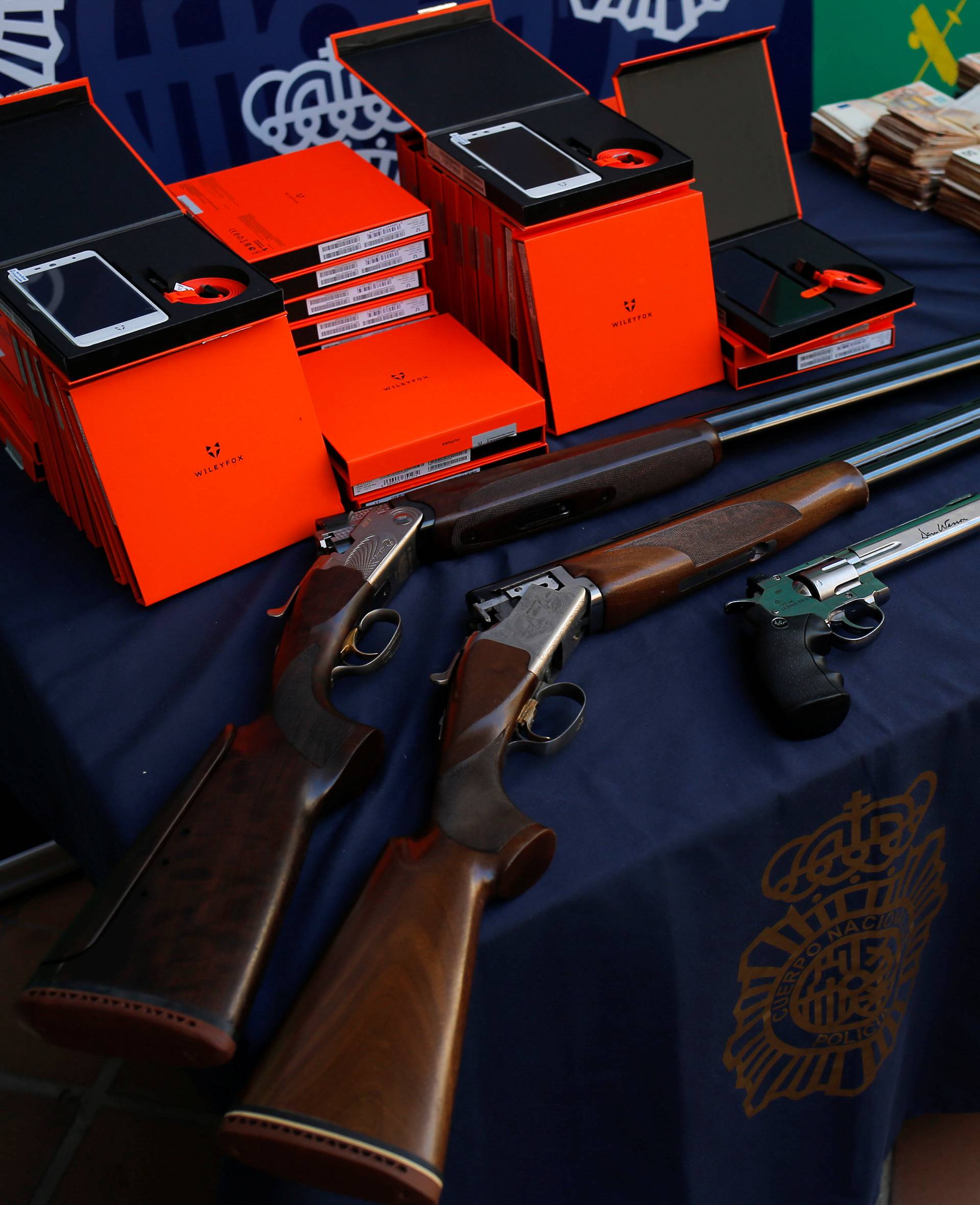 Police display arms and other material which was seized during a drug bust in which officials have seized more than six tonnes of cocaine hidden among bunches of bananas at an industrial estate at the police headquarters in Malaga