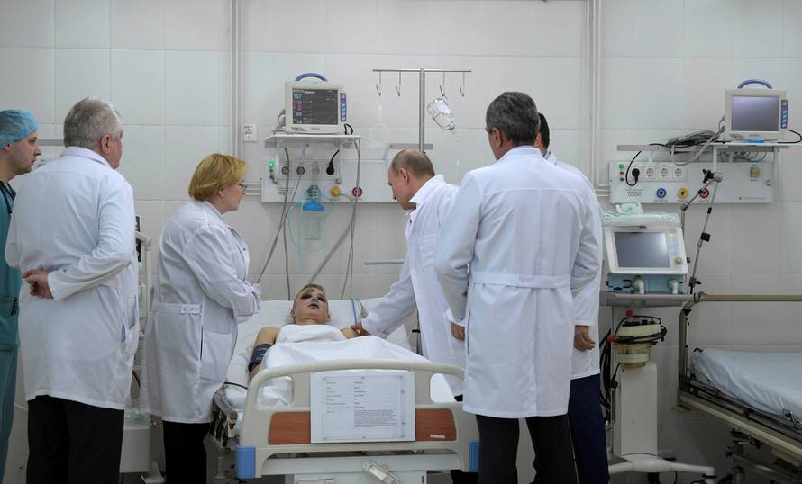Russian President Vladimir Putin meets with victims injured during a fire in a shopping mall, at a hospital in Kemerovo