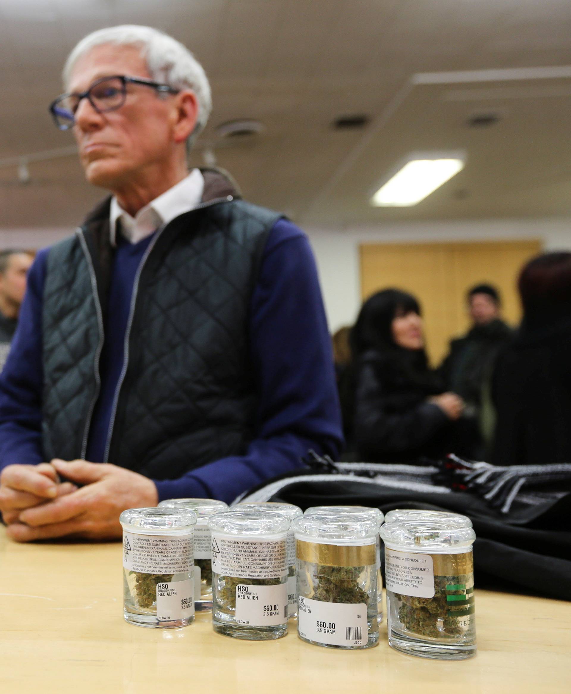 A customer waits at the counter to purchase marijuana at a dispensary in Oakland on the first day of legalized recreational marijuana sales in California