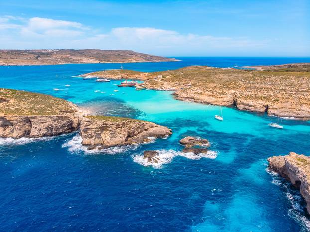 Panorama of Blue Lagoon Comino Malta. Cote Azur, turquoise clear water with white sand. Aerial view