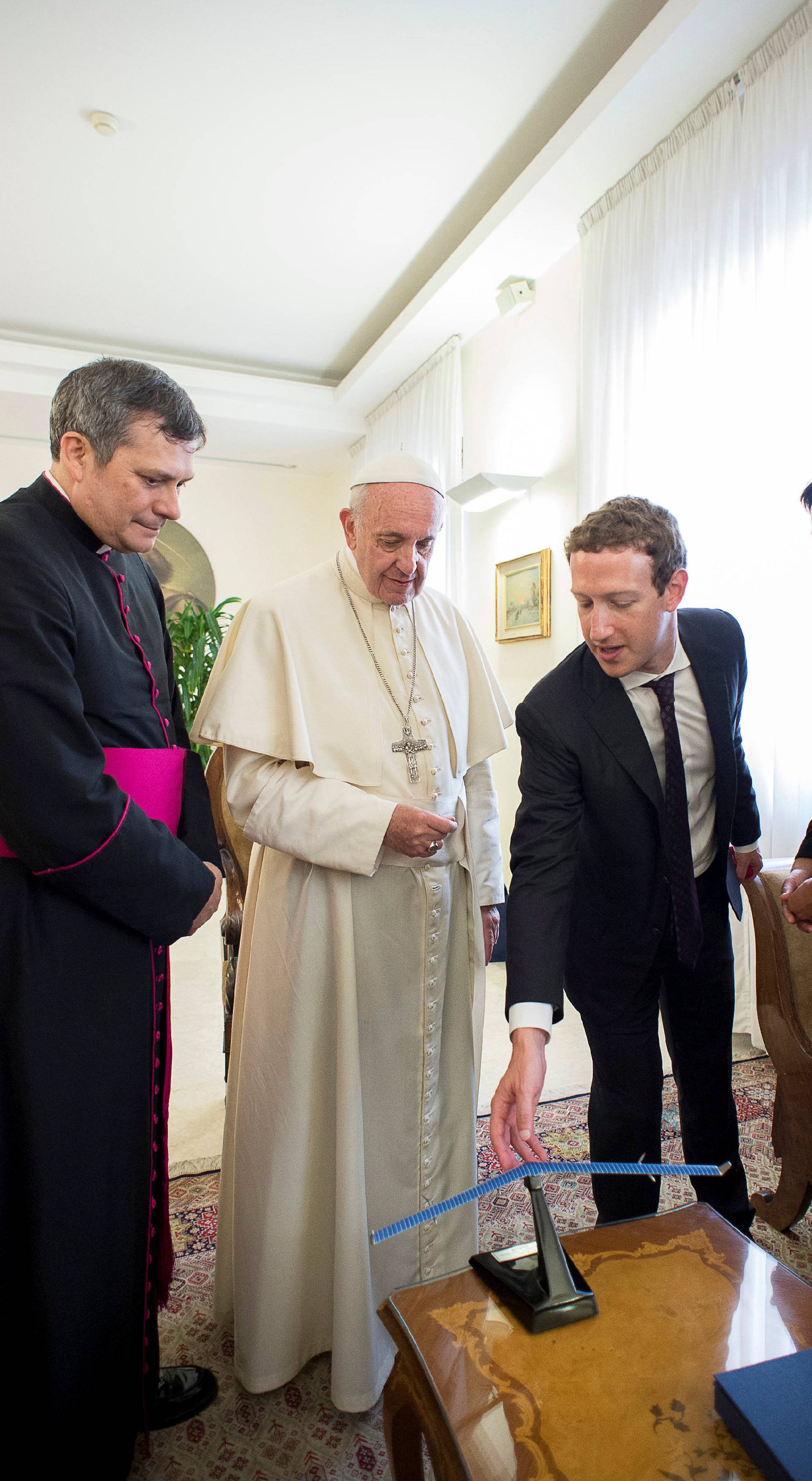 Pope Francis talks to Facebook CEO Zuckerberg and his wife Chan during a meeting at the Vatican 