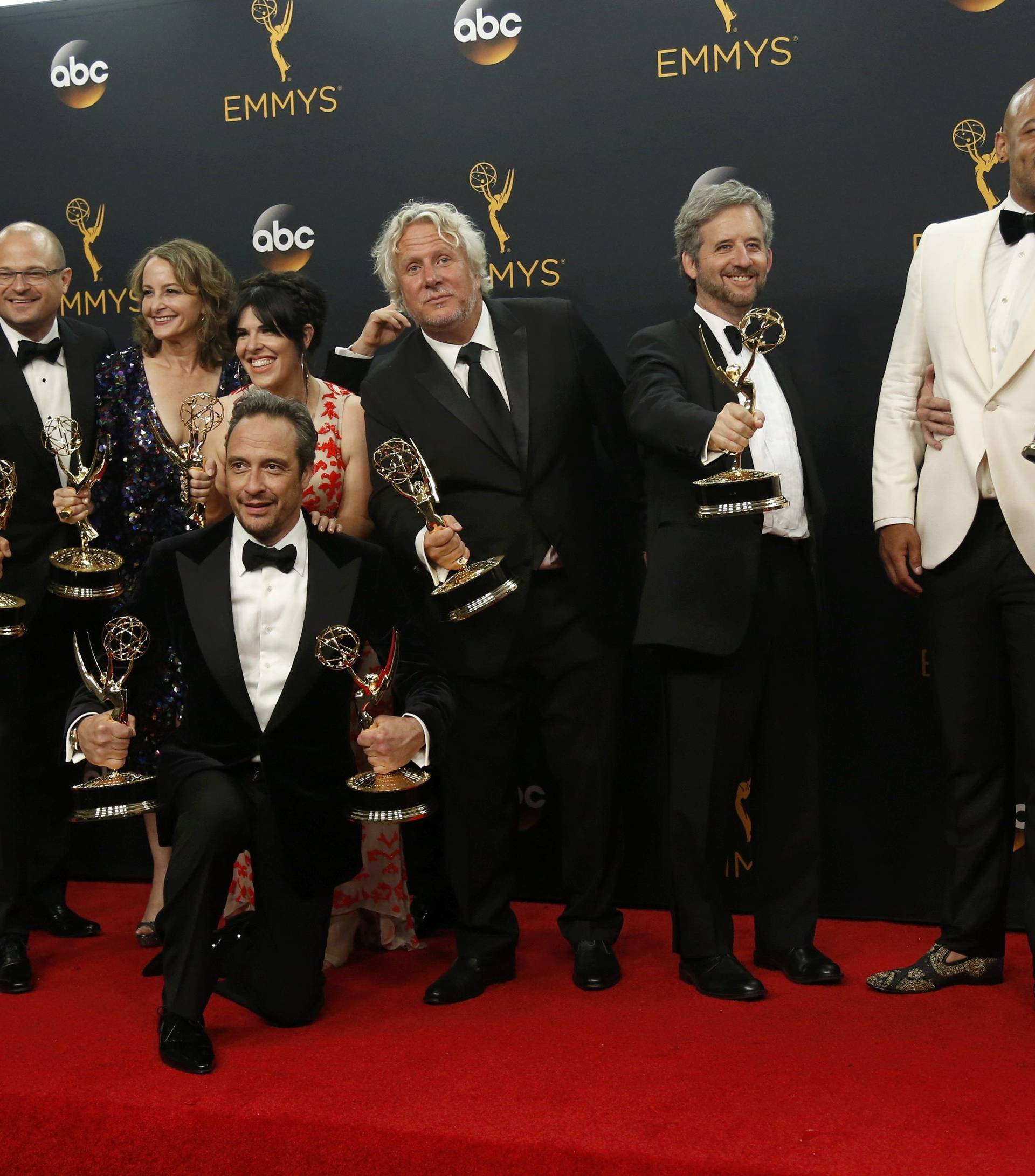 Producer Ryan Murphy poses with cast and crew backstage at the 68th Primetime Emmy Awards in Los Angeles