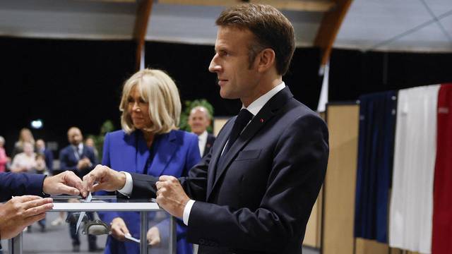 French President Macron votes in the second round of French parliamentary elections