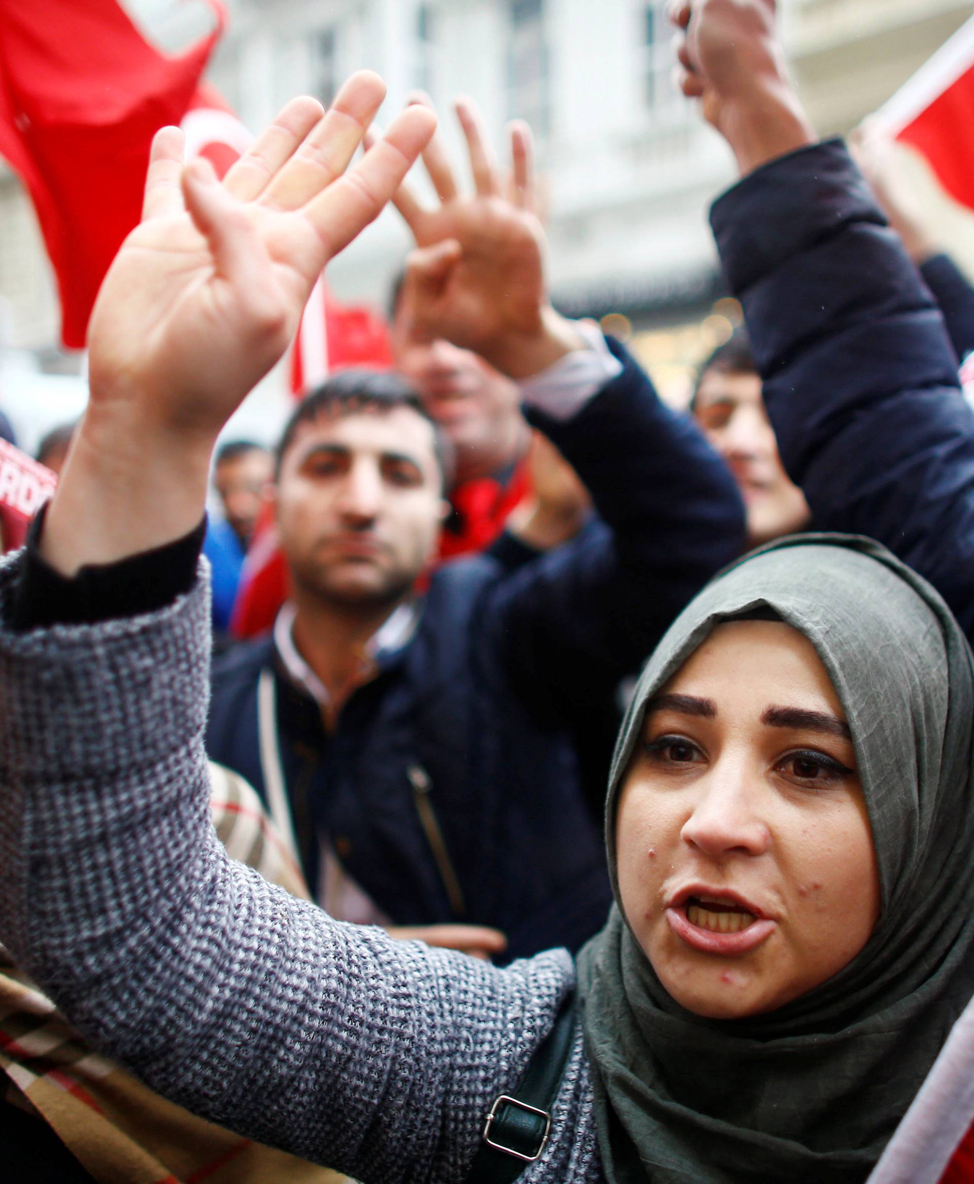 People shout slogans during a protest in front of the Dutch Consulate in Istanbul