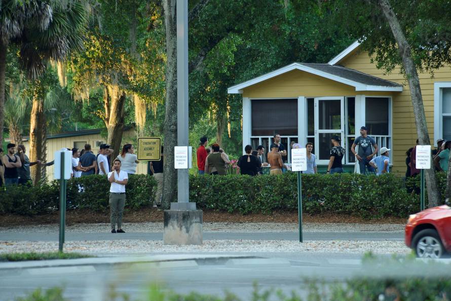 People gather as police conduct questioning near Pulse nightclub, where people were killed by a gunman in a shooting rampage in Orlando