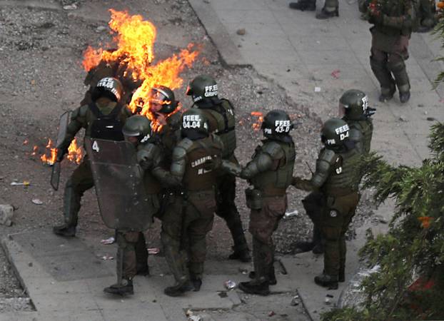 A Picture and its Story: Chilean police officers set on fire by Molotov cocktails