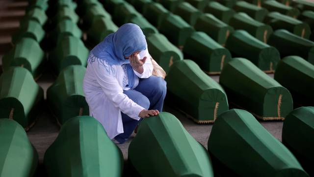 A Muslim woman cries near the coffin of her relatives, who are newly identified victims of the 1995 Srebrenica massacre and lined up for a joint burial in Potocari near Srebrenica, Bosnia and Herzegovina
