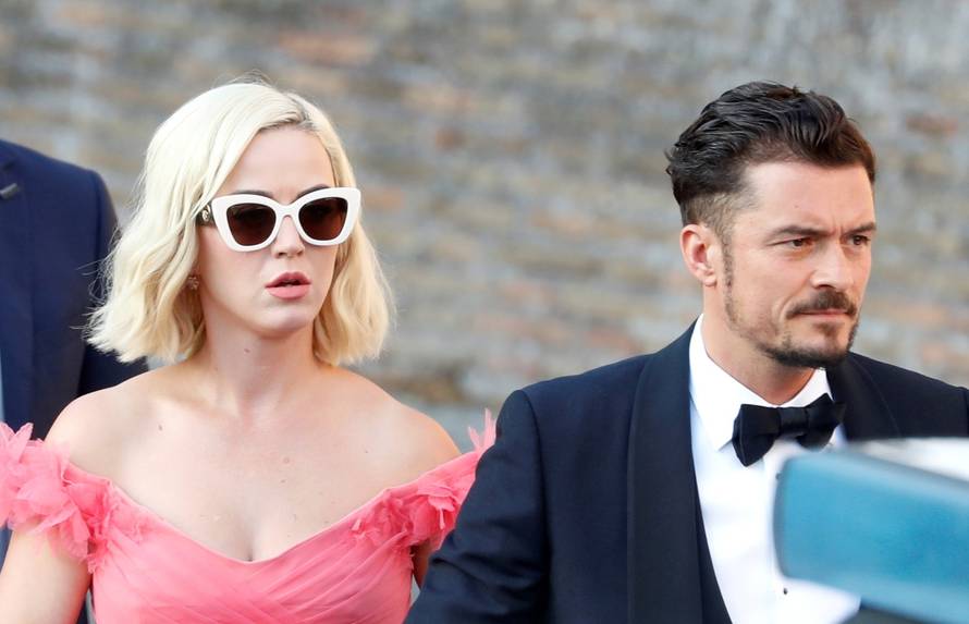 Singer Katy Perry and actor Orlando Bloom arrive to attend the wedding of fashion designer Misha Nonoo at Villa Aurelia in Rome