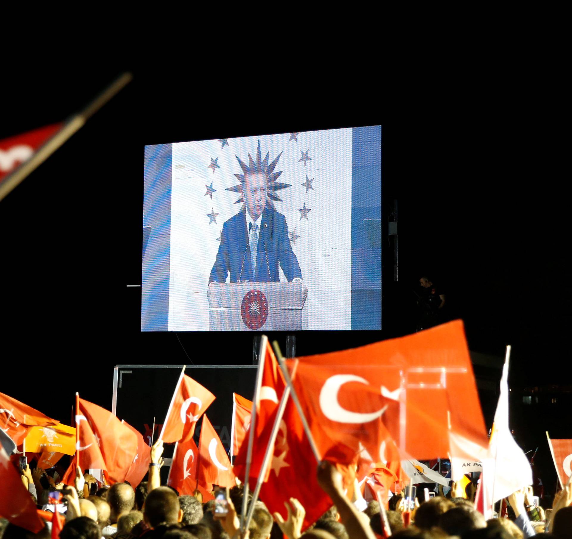 Turkish President Tayyip Erdogan is seen on the screen as he addresses his supporters in Istanbul
