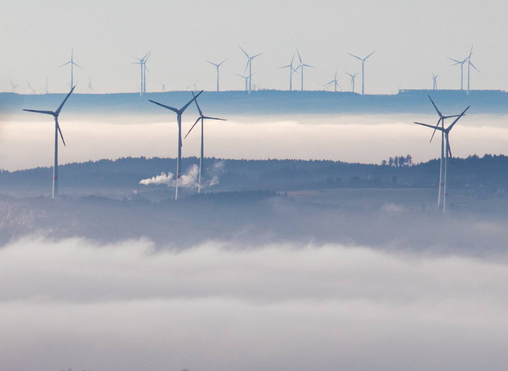 Wind mills above the fog