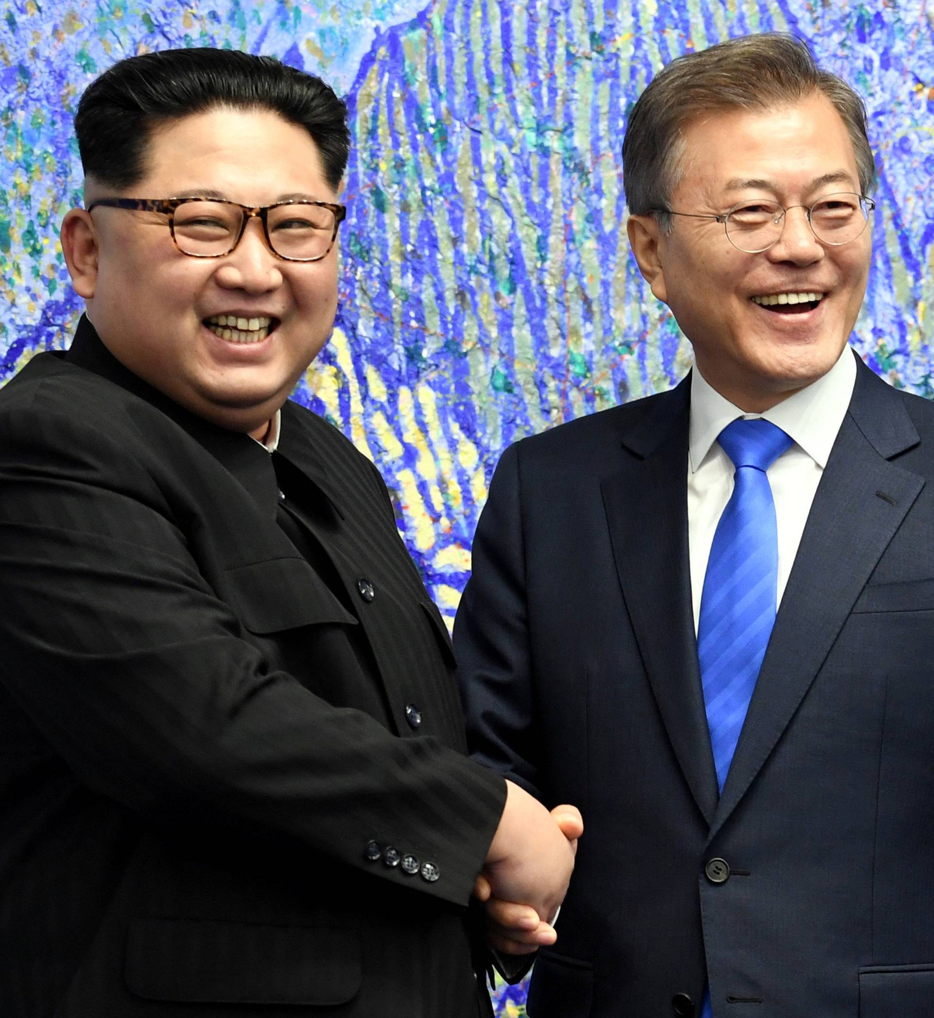 South Korean President Moon Jae-in shakes hands with North Korean leader Kim Jong Un during their meeting at the Peace House