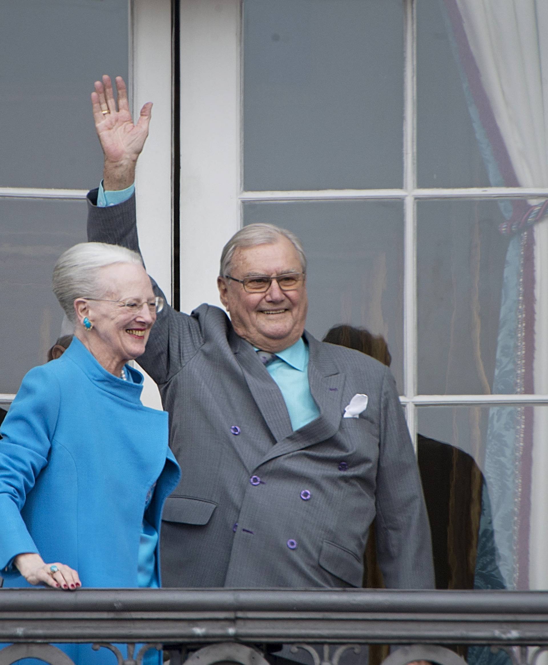 FILE PHOTO: Denmark's Queen Margrethe and Prince Henrik wave from the balcony during Queen Margrethe's 76th birthday celebration at Amalienborg Palace in Copenhagen