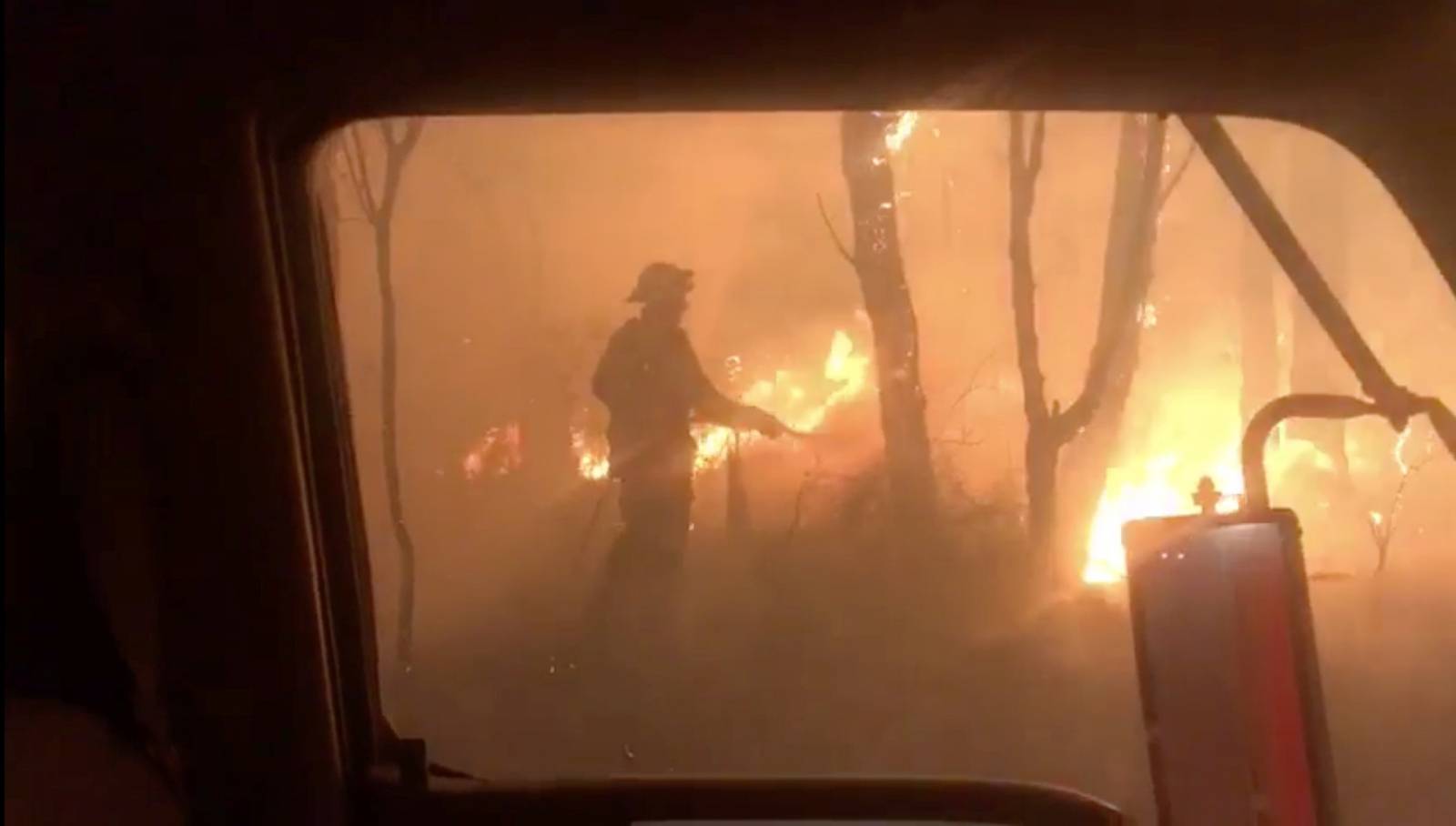 A firefighter attemps to control fire in Newnes Plateau