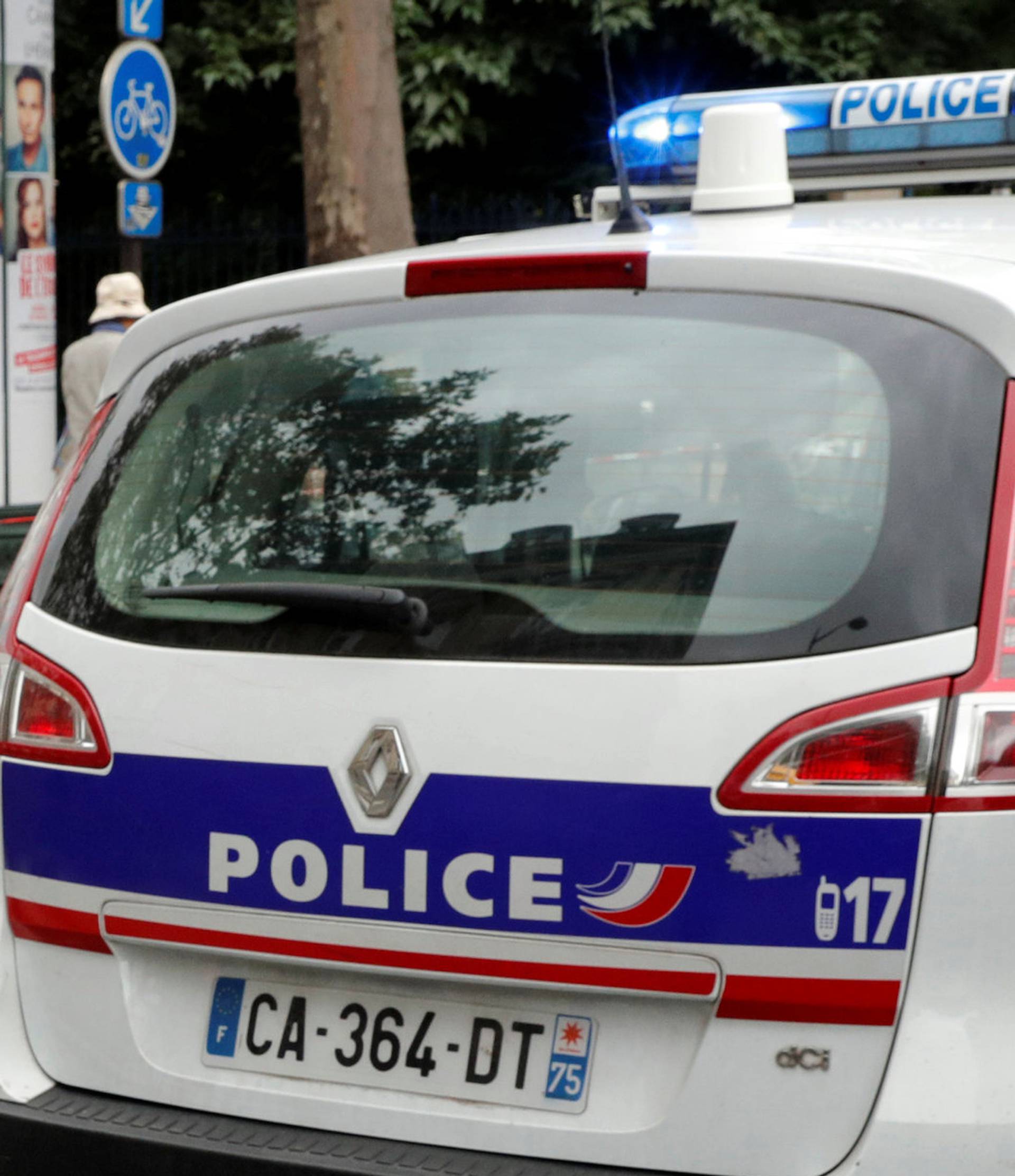 French police secure the area next to a church during a security operation in a shopping district of Paris