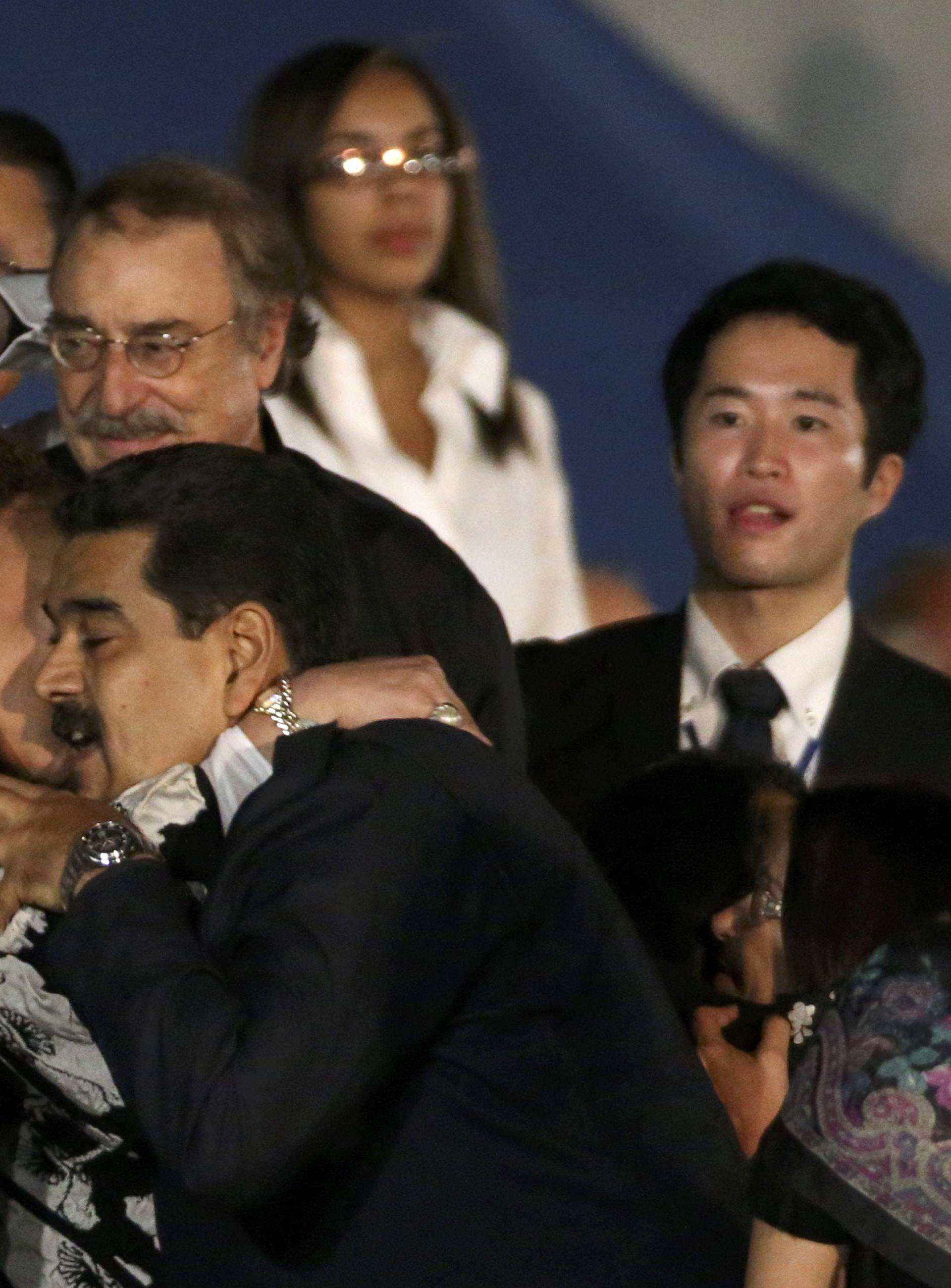 Colombia's former Senator Cordoba and Venezuelan President Maduro embrace as they attend a massive evening tribute to Cuba's late President Castro in Havana