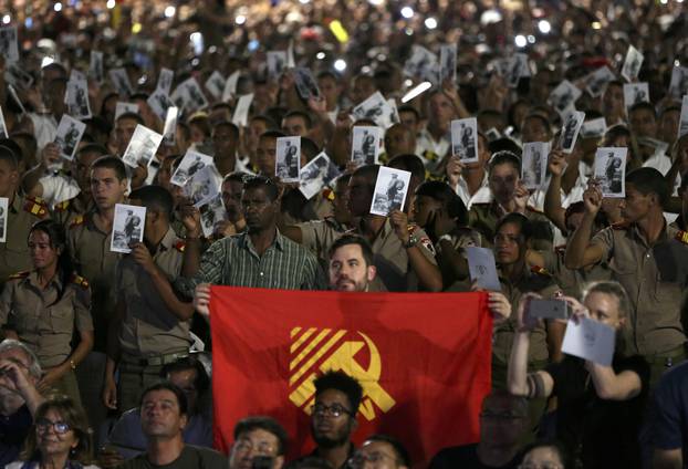 Cadets and sailors hold images of Cuba