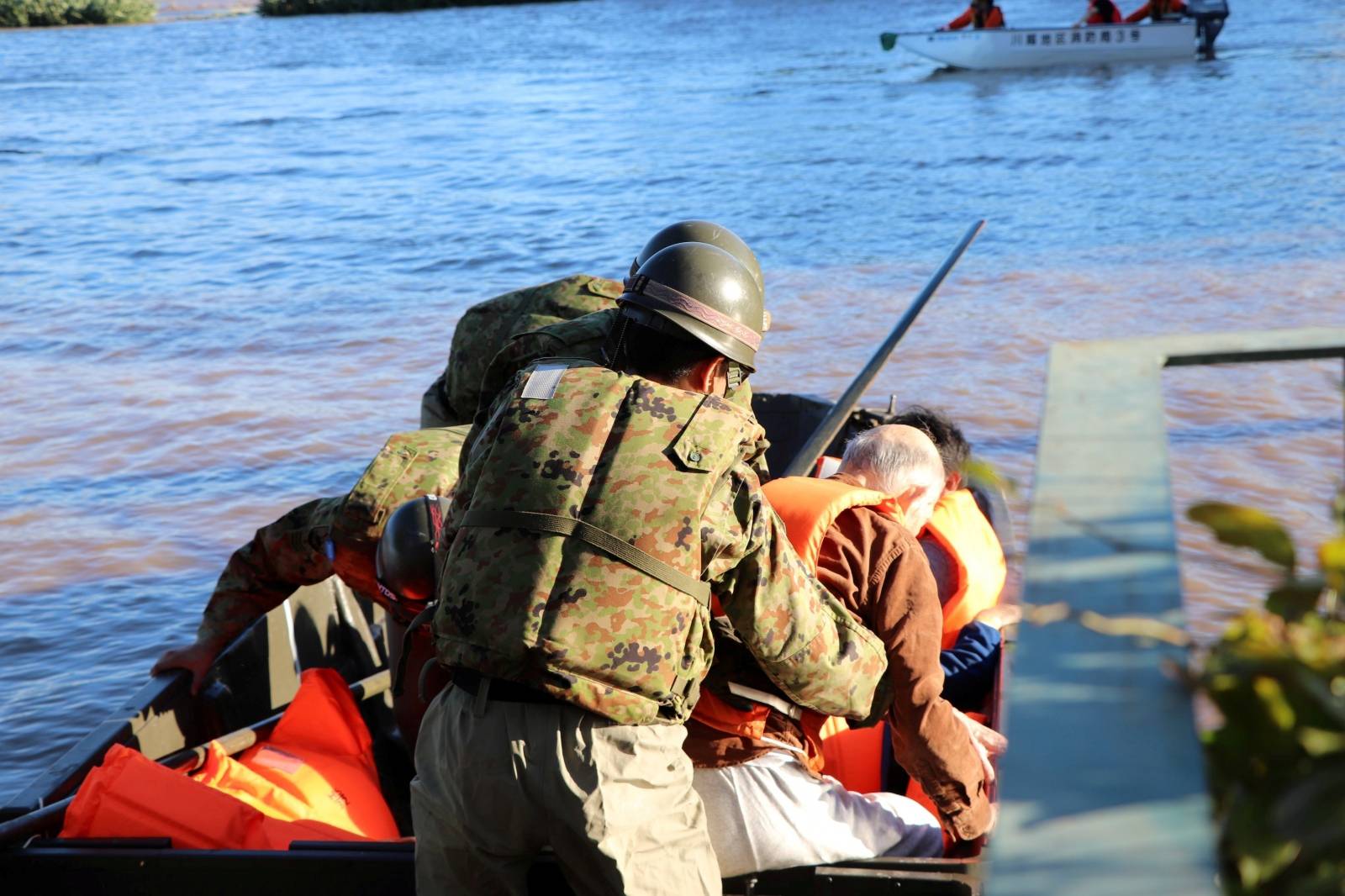 Rescue workers help residents evacuate an area after Typhoon Hagibis swept through Kawagoe, Saitama prefecture