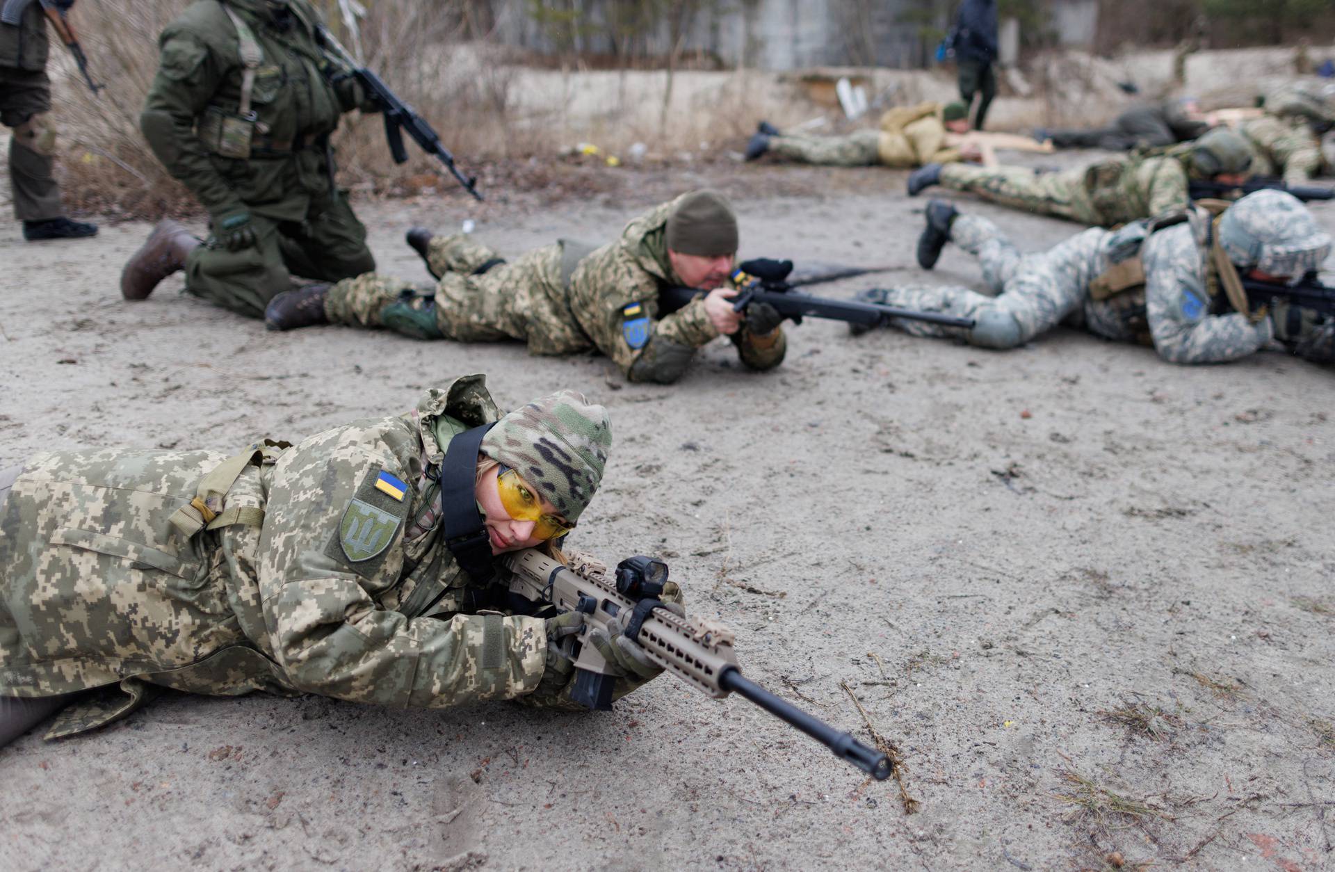 Alisa, a media relations specialist, takes part in a combat skills training conducted by the Territorial Defense Forces near Kyiv