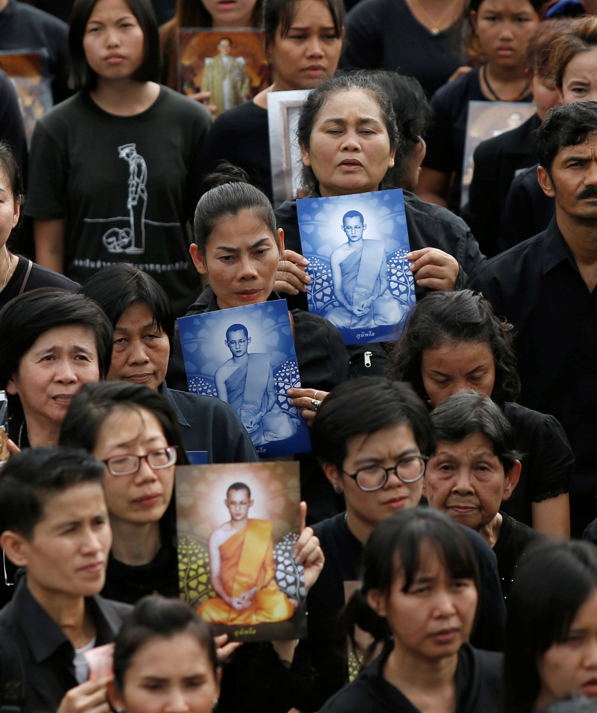 Mourners gather outside of the Grand Palace to sing for a recording of the royal anthem in honour of Thailand's late King Bhumibol Adulyadej, in Bangkok