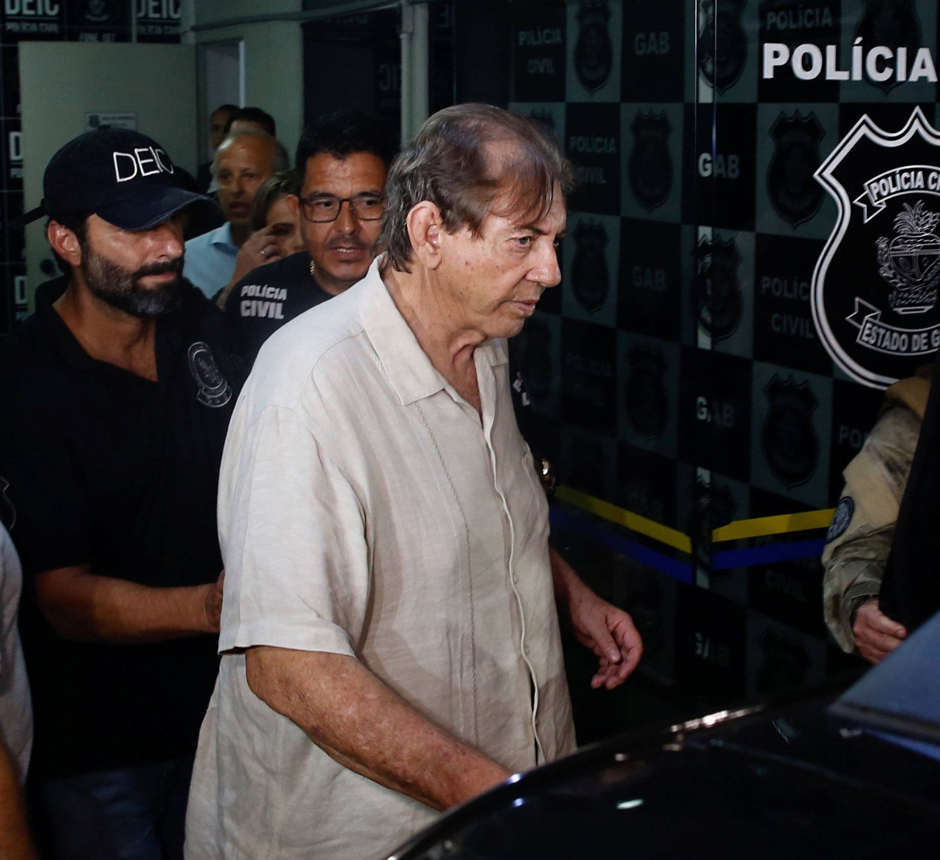 Brazilian spiritual healer Joao Teixeira de Faria, known as "John of God", arrives at the police station a day after being officially ruled a fugitive, in Goiania