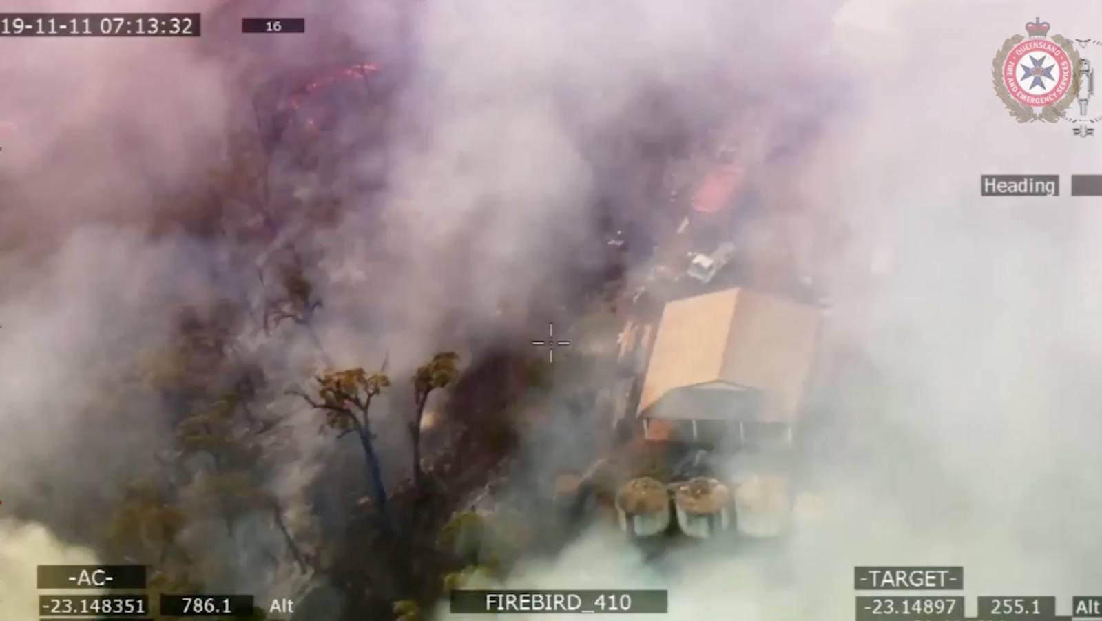 Smoke engulfs a property following the spread of bushfires in Queensland