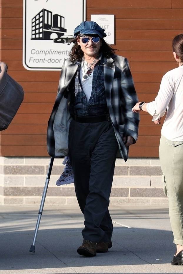 *EXCLUSIVE* Johnny Depp uses a cane while arriving in Boston for his Hollywood Vampires show after being forced to reschedule due to ankle fracture.