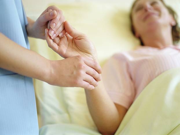 Nurse checking female patient