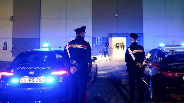 Police officers stand guard near the site where several people were injured, including Monza's football player Pablo Mari, after a stabbing incident in Assago