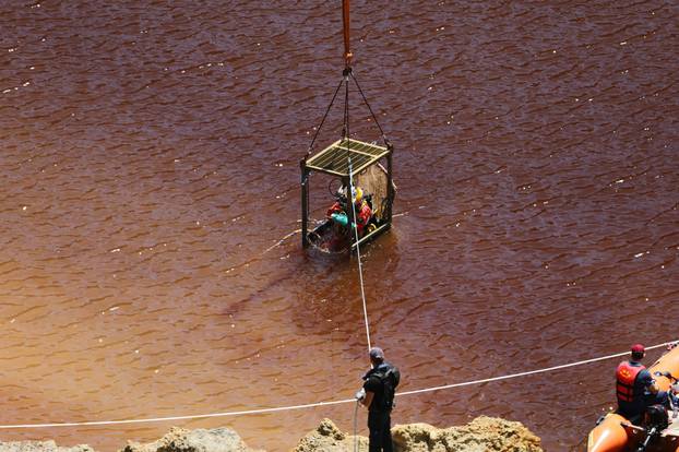 A diver prepares to dive in Kokkinopezoula lake, also known as "red lake", searching for possible bodies of victims of a suspected serial killer near the village of Mitsero