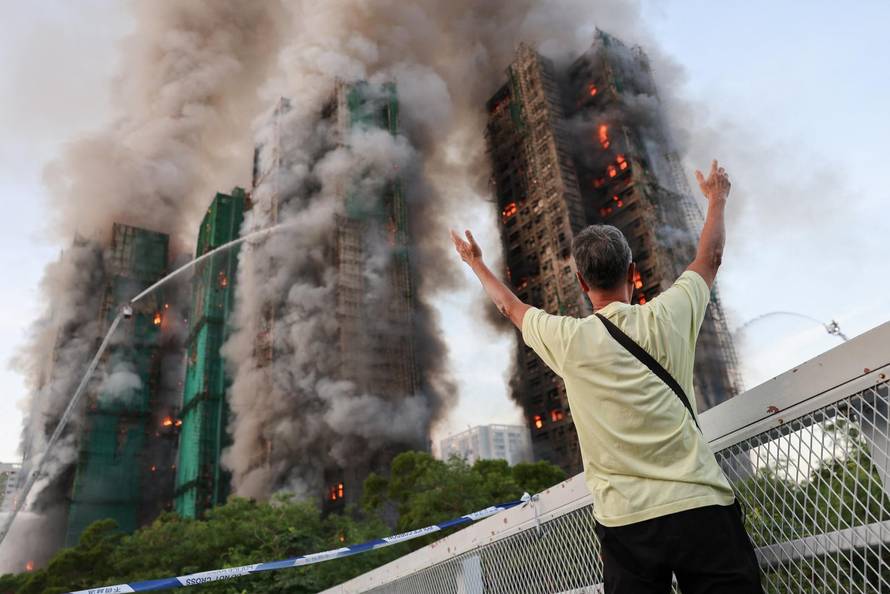 Flames engulf bamboo scaffolding across multiple buildings at Wang Fuk Court housing estate, in Tai Po