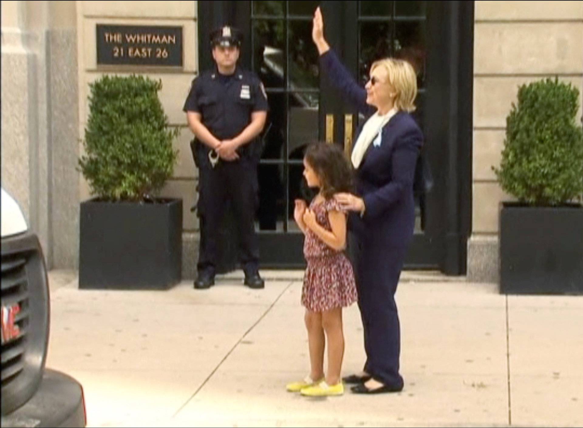 U.S. Democratic presidential nominee Hillary Clinton greets a girl on the sidewalk after leaving her daughter Chelsea's home in New York