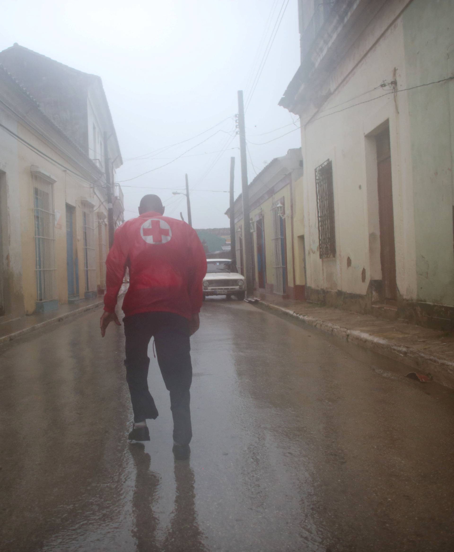 A member of the civil defense runs on the street as Hurricane Irma passes by Remedios
