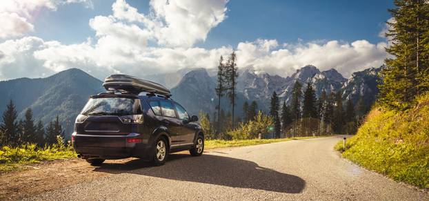 Car,For,Traveling,With,A,Mountain,Road.,Blue,Sky