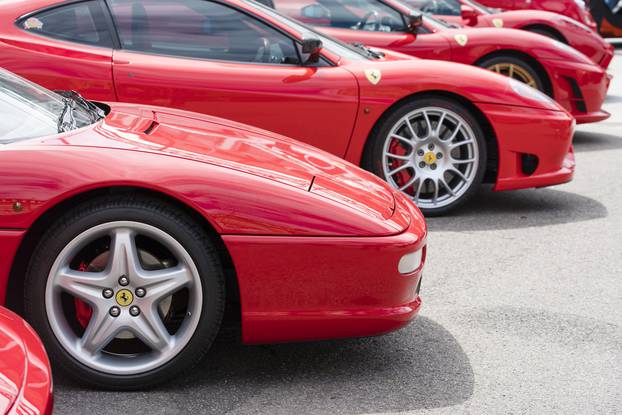 Row of red Ferrari on public display in a car