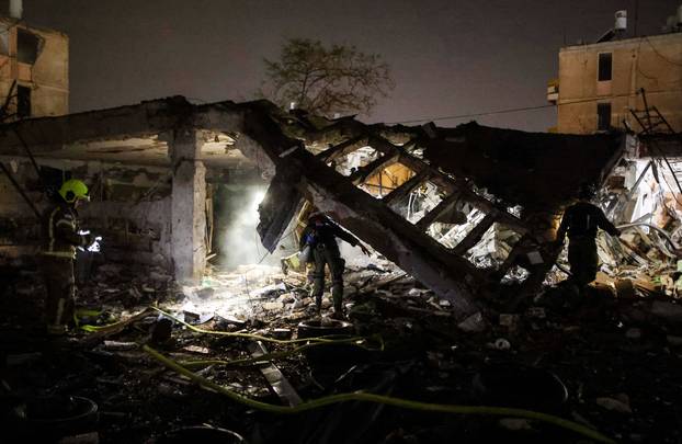 Emergency response personnel work after Iranian missile barrages struck Dimona, amid the U.S.-Israel conflict with Iran, in southern Israel
