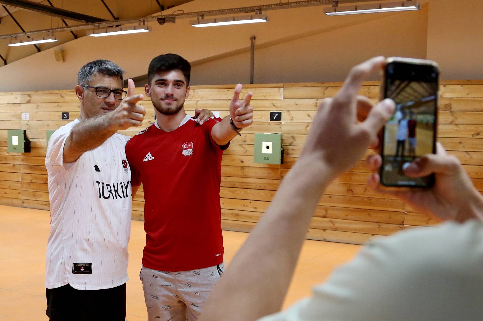 Turkish shooter Yusuf Dikec poses with a fan following a training in Ankara