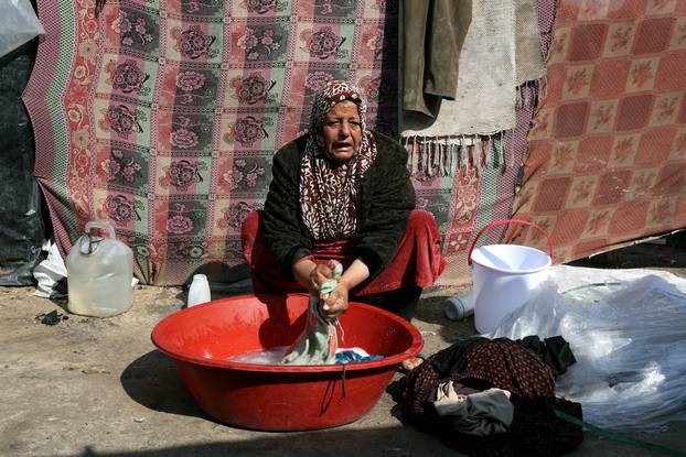 Displaced Palestinians, who fled their houses due to Israeli strikes, shelter at a tent camp in Rafah