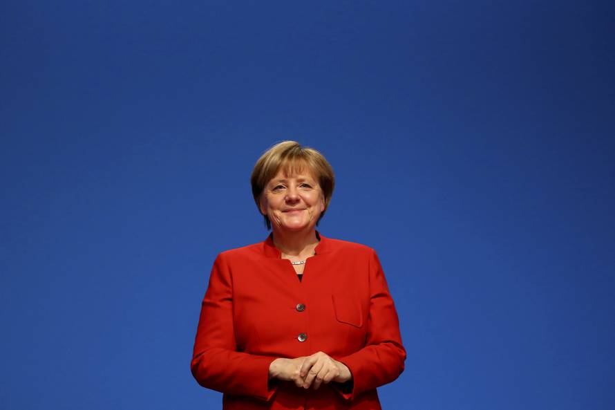 German Chancellor and leader of the conservative CDU Merkel reacts after she was re-elected as chairwoman at the CDU party convention in Essen
