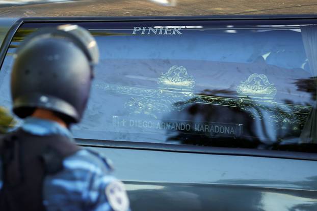 The car carrying the casket of soccer legend Diego Maradona arrives at the cemetery in Buenos Aires, Argentina