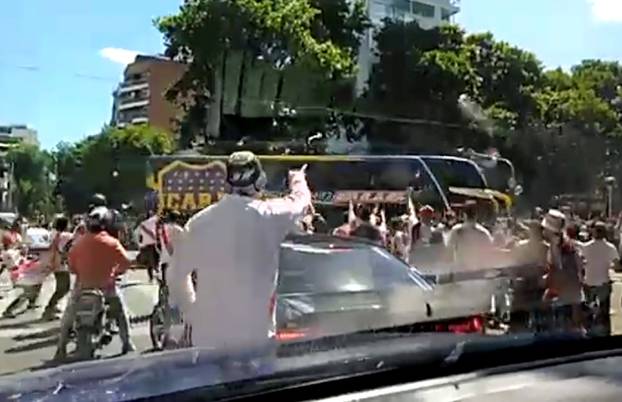 A Boca Juniors bus is attacked by opposition fans in Buenos Aires