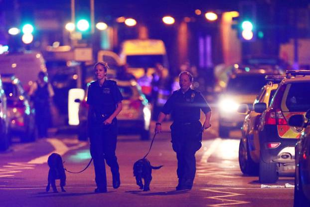 Police officers attend to the scene after a vehicle collided with pedestrians in the Finsbury Park neighbourhood of North London