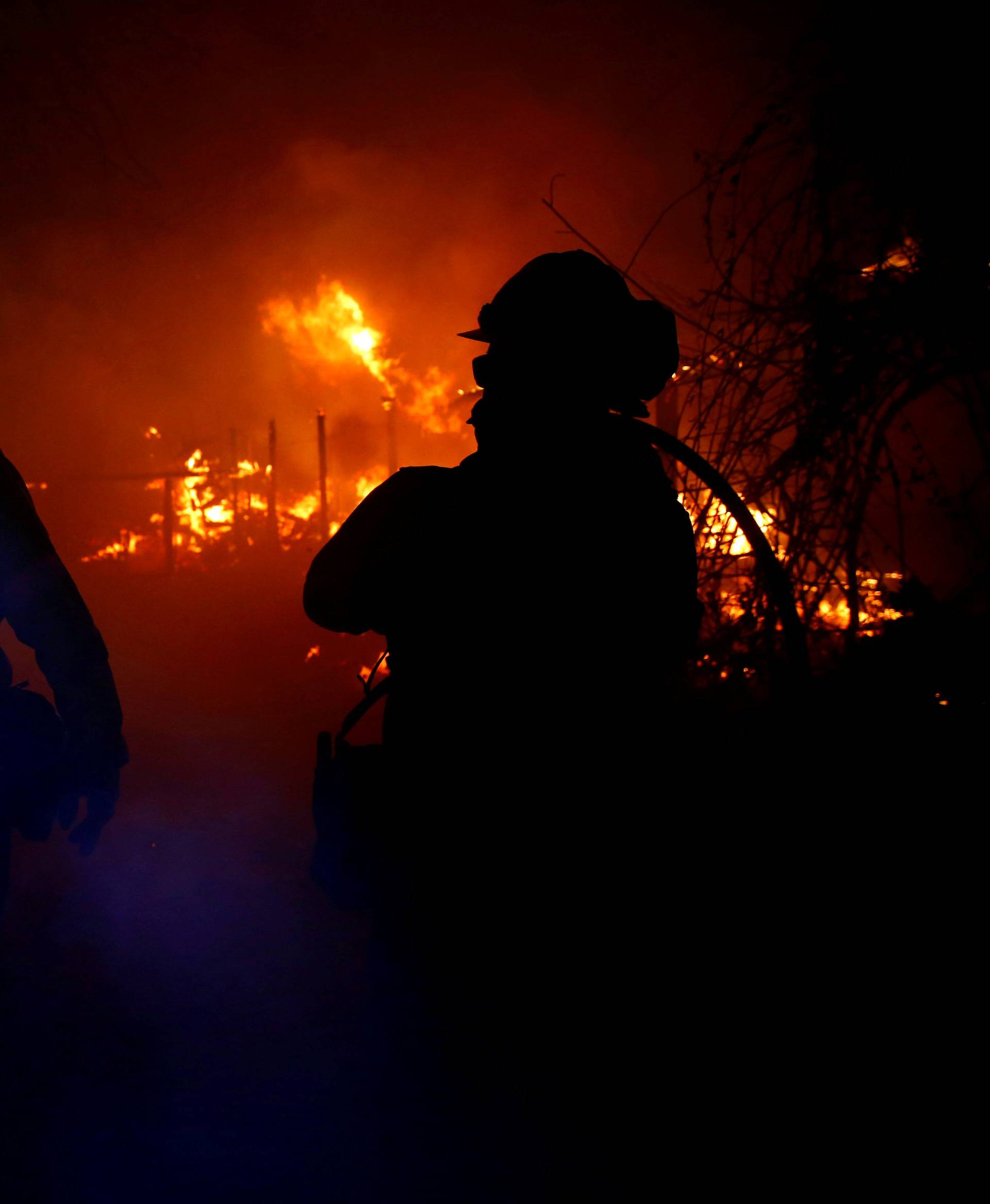 Firefighters battle the Woolsey Fire in Malibu