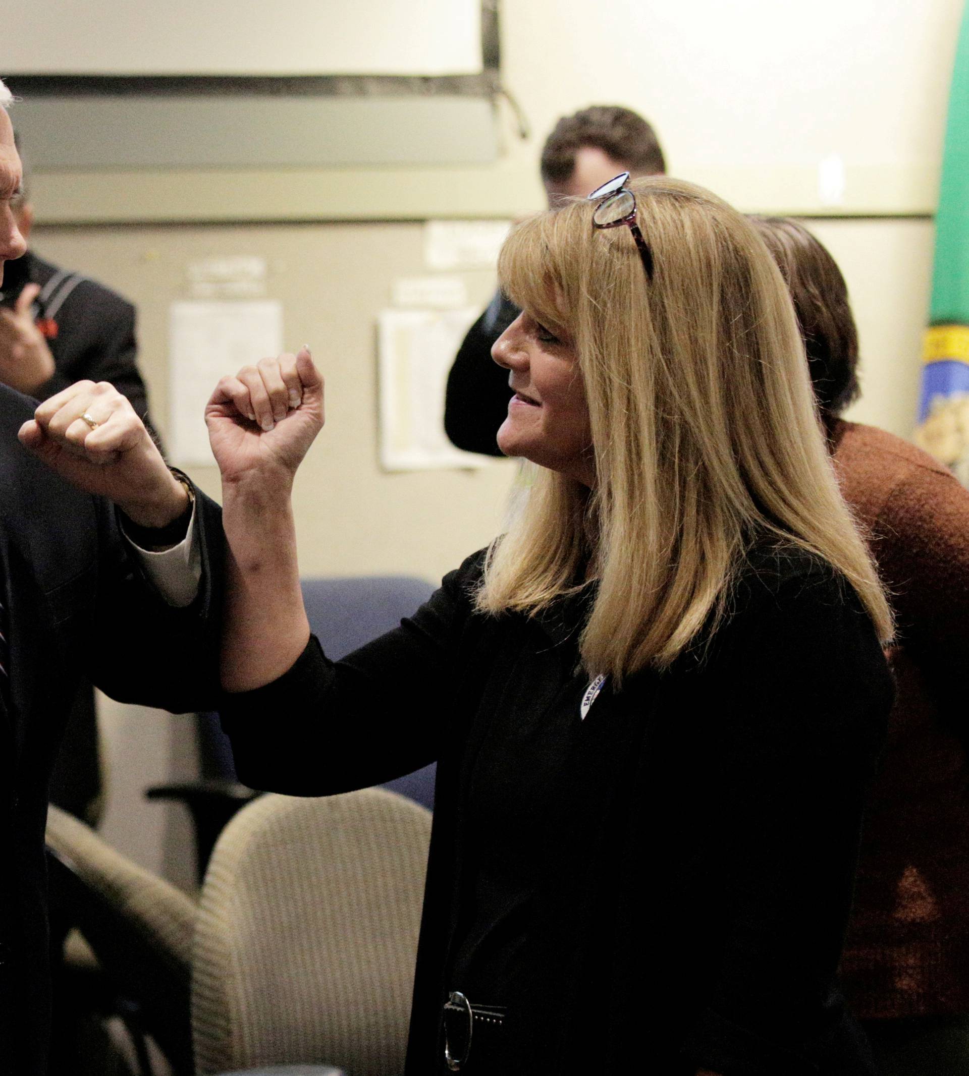 U.S. Vice President Mike Pence, who heads the government's coronavirus task force, greets a woman at the Washington State Emergency Operations Center during a tour with Governor Jay Inslee at Camp Murray near Tacoma