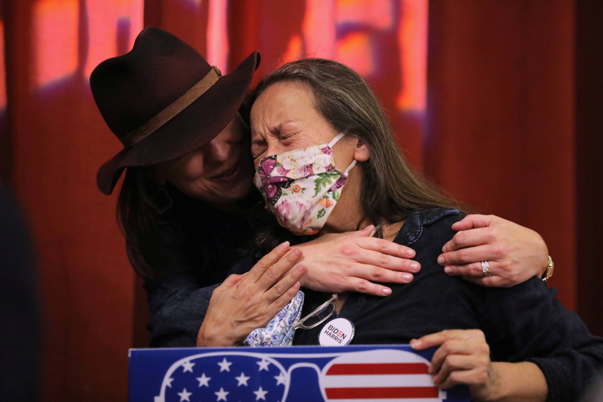 Anita Seratto-Dourron comforts her friend Jeannie Rochelle as she reacts to a victory speech by Democratic 2020 U.S. vice presidential nominee Kamala Harris at a bar in Atlanta