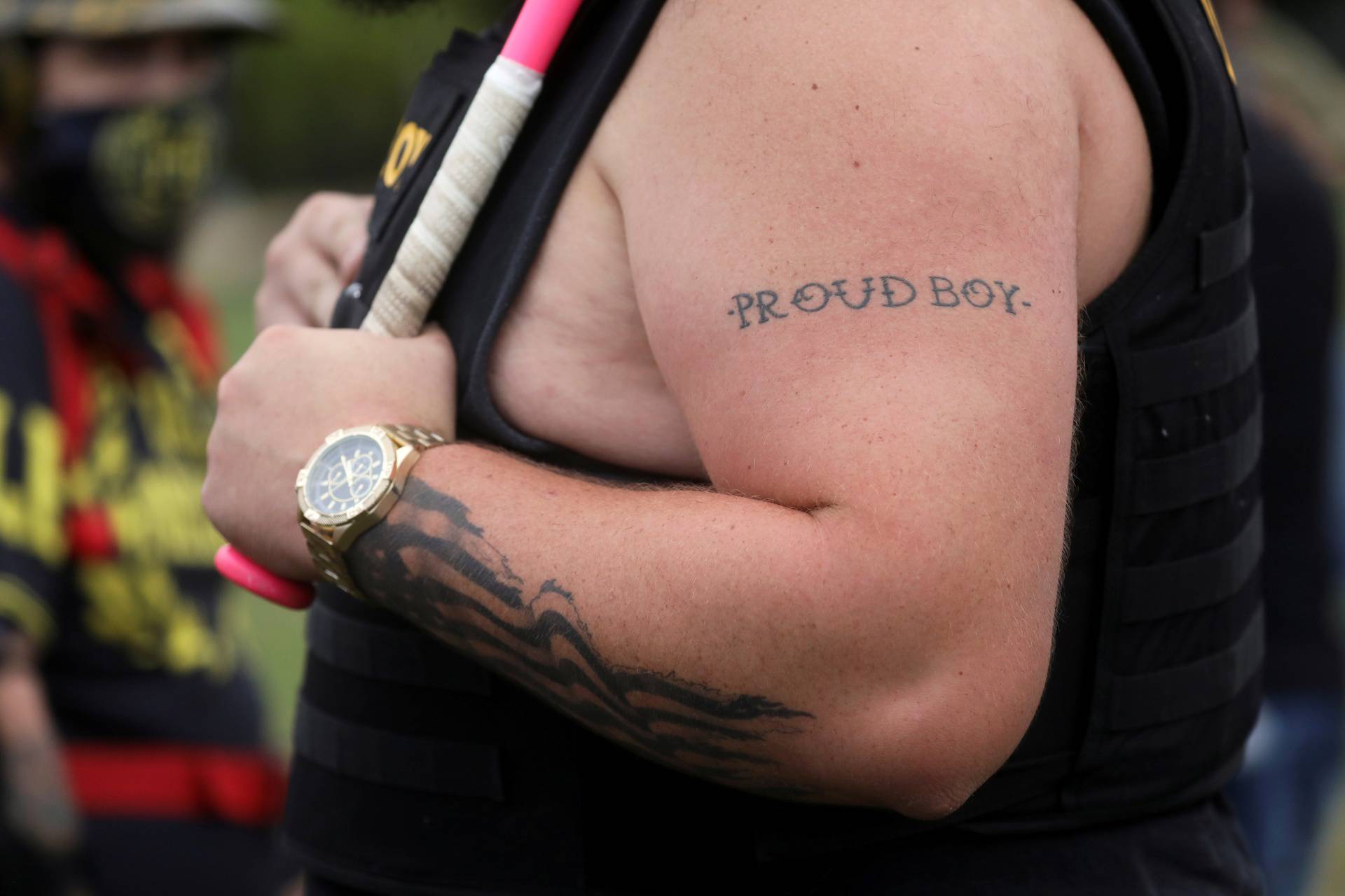 A tattoo is seen on a person's arm as people gather for a rally of the far right group Proud Boys, in Portland