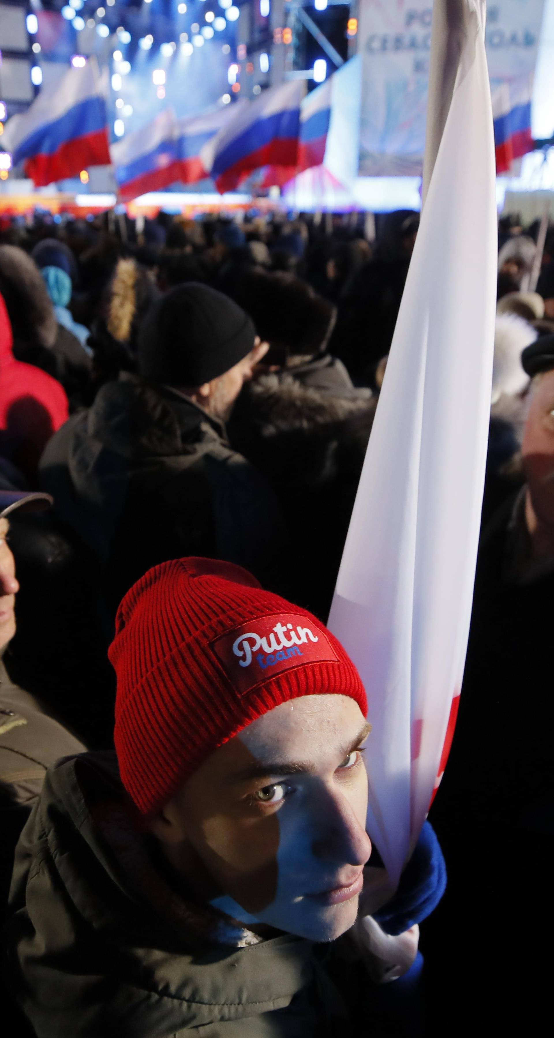 People attend a rally and concert marking the fourth anniversary of Russia's annexation of the Crimea region, at Manezhnaya Square in central Moscow