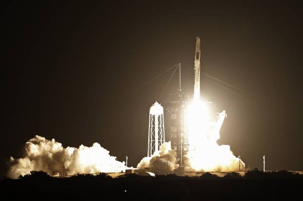 A SpaceX Falcon 9 rocket, with the Crew Dragon capsule carrying four astronauts on a NASA commercial crew mission, launches at the Kennedy Space Center
